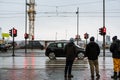 REYKJAVIK, ICELAND - 12 MAR - unidentified tourist waiting to crossing the road, with red traffic lights and zebra crossing sign