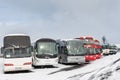 Tourist buses at the parking lot on a snowy winter day