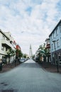 Reykjavik, Iceland - May 22, 2019: Colorful downtown streets against famous HallgrÃÂ­mskirkja church Royalty Free Stock Photo