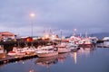 Reykjavik, Iceland - October 14, 2017: yachts at sea pier lights at dusk. Sailing boats at coast on evening sky. Water transport a