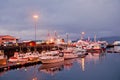 Reykjavik, Iceland - October 14, 2017: yachts at sea pier lights at dusk. Sailing boats at coast on evening sky. Water