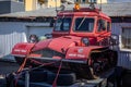 Red rescue caterpillar tractor vehicle in front of Bjorgunarmidstod (Hjalparsveit), Kopavogur, Iceland.