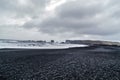 Reynisfjara black sand beach in Iceland at winter. Famous Reynisdrangar rock formations at black Reynisfjara Beach.