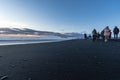 Reynisfjara black sand beach at sunset illuminated by the last rays