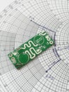 RF PCB in front of Smith chart Royalty Free Stock Photo