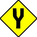 Vector illustration of a warning sign for a fork in road. Yellow and black caution sign drawing. Royalty Free Stock Photo