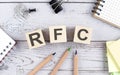 RFC Request for Comments text on wooden block with office tools on the wooden background
