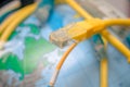 RG-45 plug is a close-up. Terminal end on the background of the globe. The concept of global communication on earth. Server Royalty Free Stock Photo