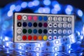 RGB LED light strip with remote control in front of colorful bokeh metal diamond plate background Royalty Free Stock Photo