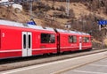 Rhaetian Railway train leaving the Filisur railway station in Sw Royalty Free Stock Photo