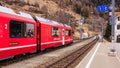 Rhaetian Railway train leaving the Filisur railway station in Switzerland