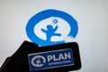 Rheinbach, Germany 1 April 2022, The brand logo of the aid organization `Plan International` on the display of a smartphone