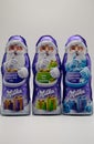 RHEINBACH, GERMANY 08 December 2020, Three purple Milka Santa Clauses in different flavors on a white background