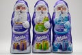 RHEINBACH, GERMANY 08 December 2020, Three purple Milka Santa Clauses in different flavors on a white background