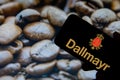 Rheinbach, Germany 1 October 2021, The brand logo of `Dallmayr` on the display of a smartphone in front of a picture with roast