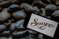 Rheinbach, Germany 1 October 2021, The brand logo of `Senseo` on the display of a smartphone in front of a picture with roasted