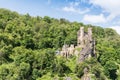 Rheinstein Castle on the river Rhine in Germany, surrounded by dense woodland, on a sunny summer\'s day Royalty Free Stock Photo