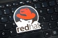 RHEL OS, Red Hat Enterprise Linux operating system commercial market distribution logo, symbol, sticker on a laptop keyboard Royalty Free Stock Photo