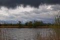 River delta view of lake and alpine landscape by storm clouds Royalty Free Stock Photo