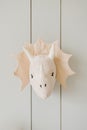 Rhinoceros or dinosaur on the wall. Stylish Scandinavian children`s room with a decorated wooden wall