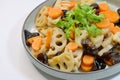 Home-cooked dish of stir-fried lotus roots, carrots, wood ear fungus, garnished with Chinese parsley