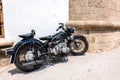 Narrow cobbled historical streets of Rhodes. Vintage scooter bike is parked old stone against wall of house, Rhodes