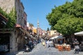 RHODES, Greece - JUN 07, 2021. Tourists walk along the shops of the famous Socrates Street in the old town of Rhodes. Street Royalty Free Stock Photo