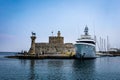 A big white touristic cruise ship moored in Mandraki harbour, Rhodes town, Greece.