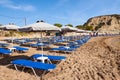 Sun loungers with umbrellas on sandy Kolymbia beach. Rhodes island, Greece Royalty Free Stock Photo