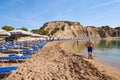 Sun loungers with umbrellas on sandy Kolymbia beach. Rhodes island, Greece Royalty Free Stock Photo