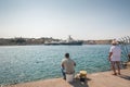 05/30/2018, Rhodes, Greece. Two fishermen at Akti Sachtouri sea promenade