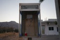 An old payphone booth without a payphone set. A payphone is typically a coin-operated public telephone. Kolympia, Rhodes, Greece Royalty Free Stock Photo