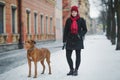 Rhodesian ridgeback with a host in the winter for a walk in the city. girl with a dog Royalty Free Stock Photo