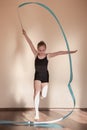 Rhythmic gymnastics. Graceful girl in motion