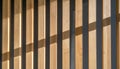 Rhythmic Light and Shadow on a Wooden Facade Royalty Free Stock Photo