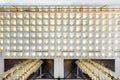 Rhythmic texture on suspended ceiling with rows of halogen spots lamps and drywall construction with chandelier. Stretch ceiling