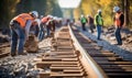 The rhythmic thud of the sledgehammer echoed as workers drove spikes into the wooden railroad ties