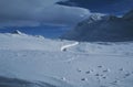 The RhÃÂ¤tische Railyway mÃÂ¤anders in the deep snow of the swiss alps at Bernina Pass Royalty Free Stock Photo