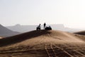 Riad, Saudi Arabia, February 15 2020: Two young Saudis take a break with their quads on the top of a red sand dune south of Riyadh