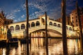 The Rialto bridge, night view from the wharf of gondolas Royalty Free Stock Photo