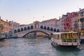 Rialto Bridge across Grand Canal at sunrise / sunset time, Venice, Italy Royalty Free Stock Photo