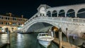 Rialto Bridge or Ponte di Rialto over Grand Canal timelapse at night in Venice, Italy. Royalty Free Stock Photo