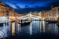 The Rialto Bridge in Venice, Italy with a Gondola on the Canale Grande Royalty Free Stock Photo