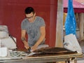 Fishmonger working at Rialto Fish Market by the grand canal Venice Italy Royalty Free Stock Photo