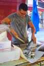 Fishmonger working at Rialto Fish Market by the grand canal Venice Italy Royalty Free Stock Photo