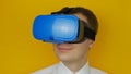 Riant happy man in blue head-mounted display looks around, virtual reality, hmd 360