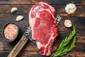 Rib eye steak on a meat cleaver. Raw Marble beef black Angus, ribeye. Dark wooden background. Top view Royalty Free Stock Photo