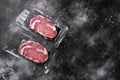 Rib eye steak pack, on black dark stone table background, top view flat lay, with copy space for text Royalty Free Stock Photo