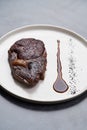 Rib eye steak on white plate, close-up. Sliced tenderloin steak Royalty Free Stock Photo