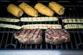 Rib eye steak with zucchini and corn on gas grill Royalty Free Stock Photo